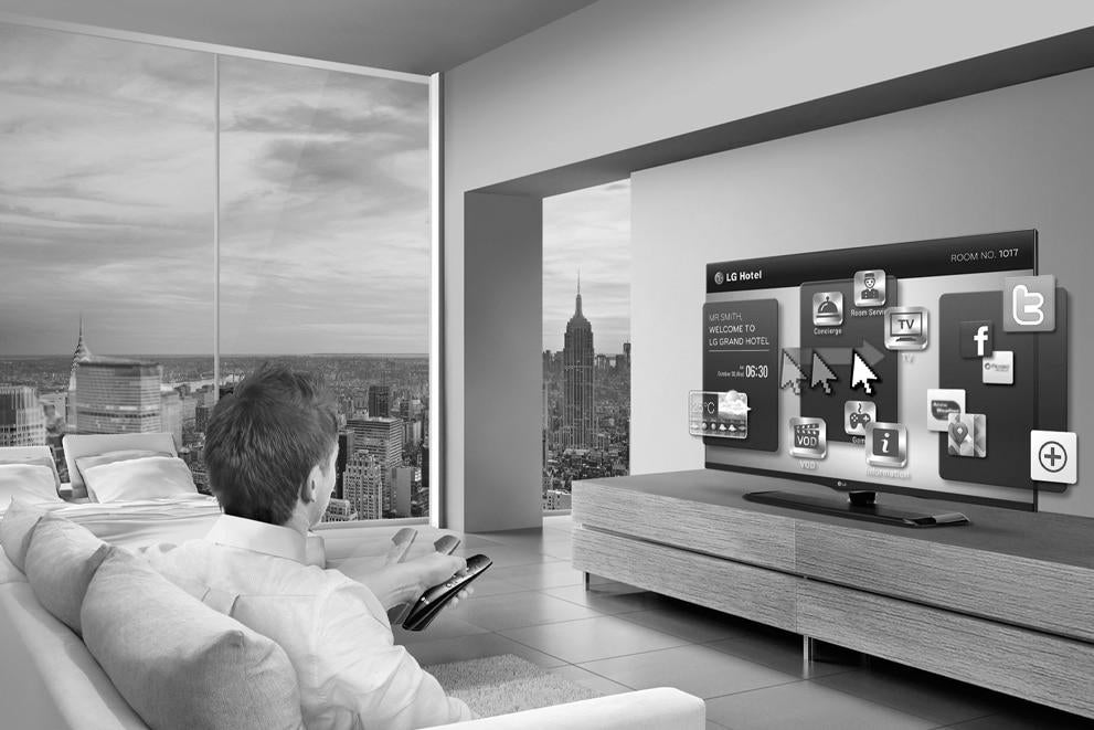 Man watching hotel TV LG Pro:idiom in high end room